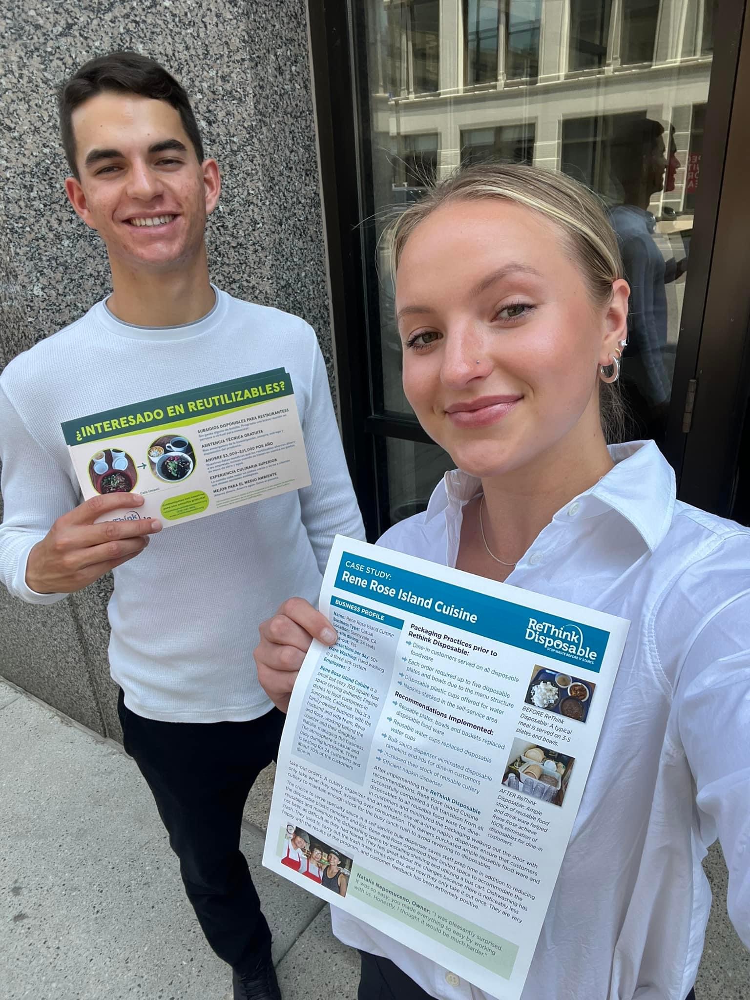 Alex Perez and Chloe Kintop pose with informational flyers about ReThink Disposable