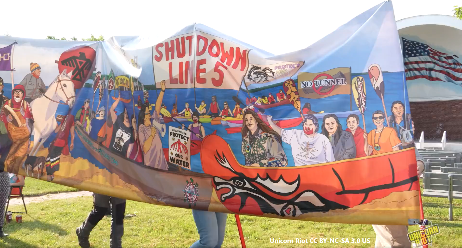 Shut Down Line 5 banner from Wisconsin Protest including "No Tunnel" "Protect Our Water", and Indigenous activists