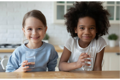 Image of two kids drinking water