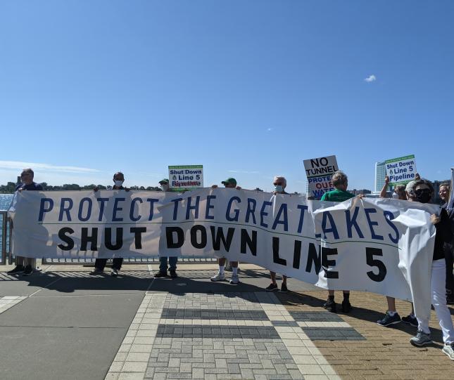 Protestors holding banner: Protect the Great Lakes Shut Down Line 5. Source: Jennifer Schlicht