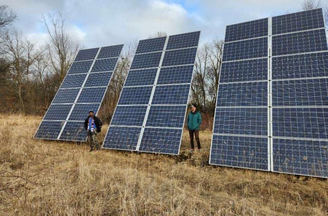 Organizers with The Public Power Project including Clean Water's Erik McCleary posting by solar panels