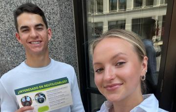 Alex Perez and Chloe Kintop pose with informational flyers about ReThink Disposable