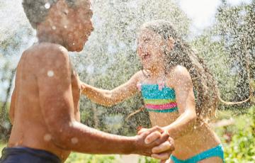 Kids splashing in water and nature. 