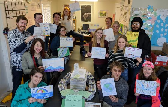 Michigan canvass staff posing with letter and postcard actions taken. Credit Jennifer Schlicht. 