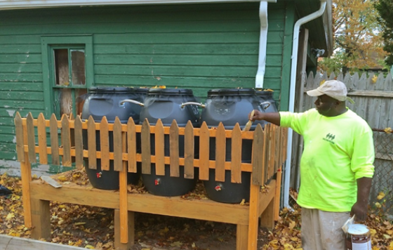 Image of Franciscan Charities organization installing fencing around a rain barrel project in Newark, NJ