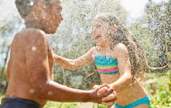 Kids splashing in water and nature. 